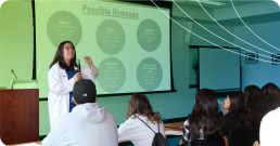 A woman talking to a group of studentrs