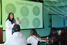 A woman talking to a group of studentrs